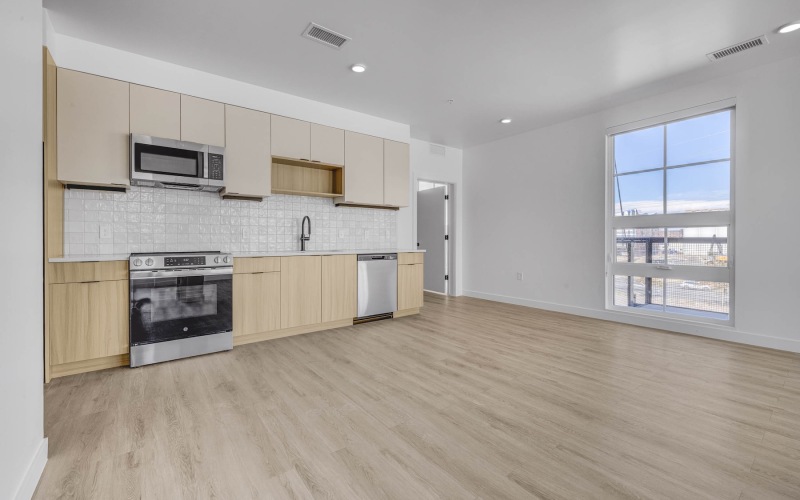 Refined spaces to match your style a kitchen and an empty living room with a laundry closet