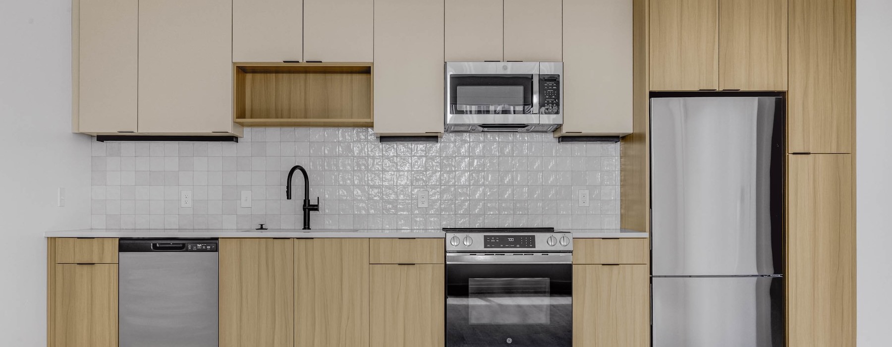 Spacious kitchens with thoughtful details a kitchen with wooden cabinets