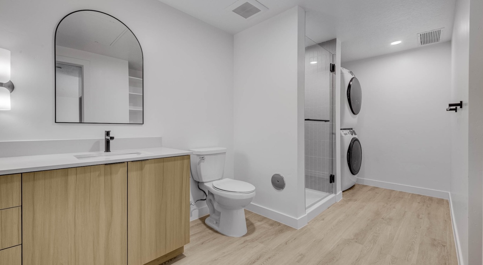 Spacious bathrooms with everything you need a bathroom with a sink, toilet and a laundry area