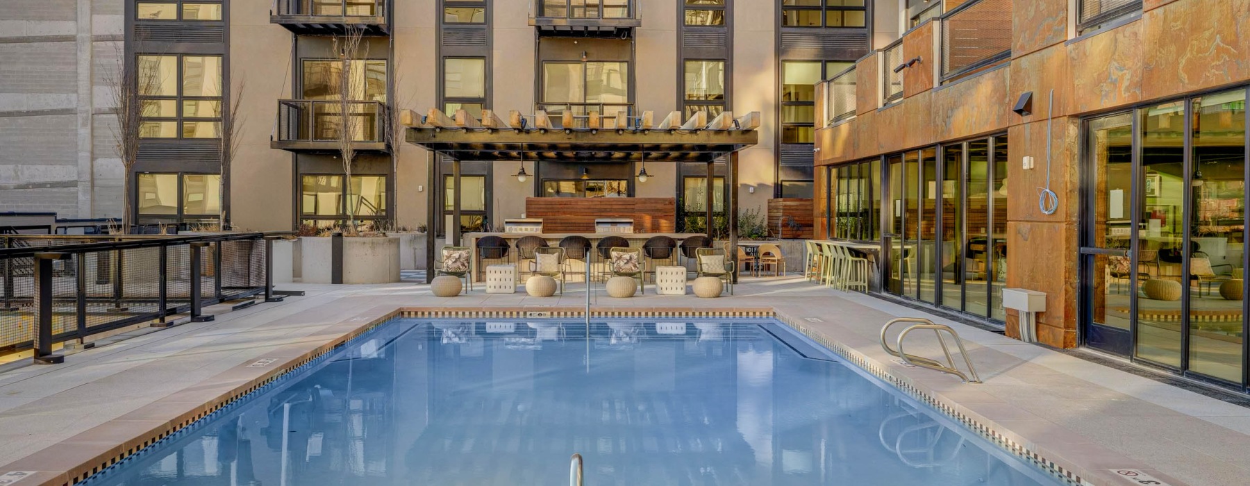 Luxury pool with loungers at Journeyman apartments in Salt Lake City.